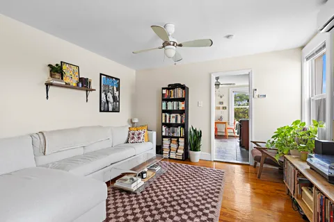 a living room with furniture and a book shelf