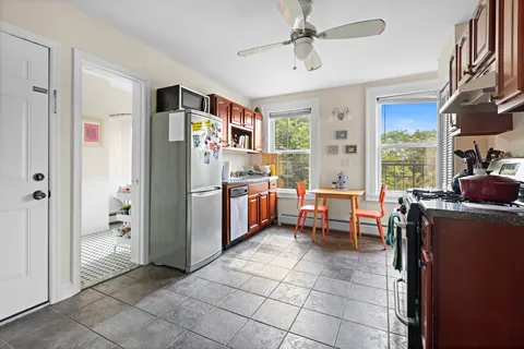 a living room with furniture a dining table and a window