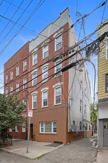an aerial view of residential house with outdoor space and trees