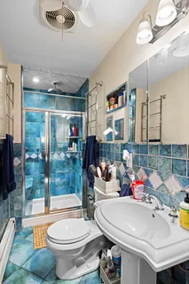 a bathroom with a sink mirror toilet and shower
