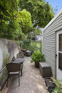 a backyard of a house with a table and chairs