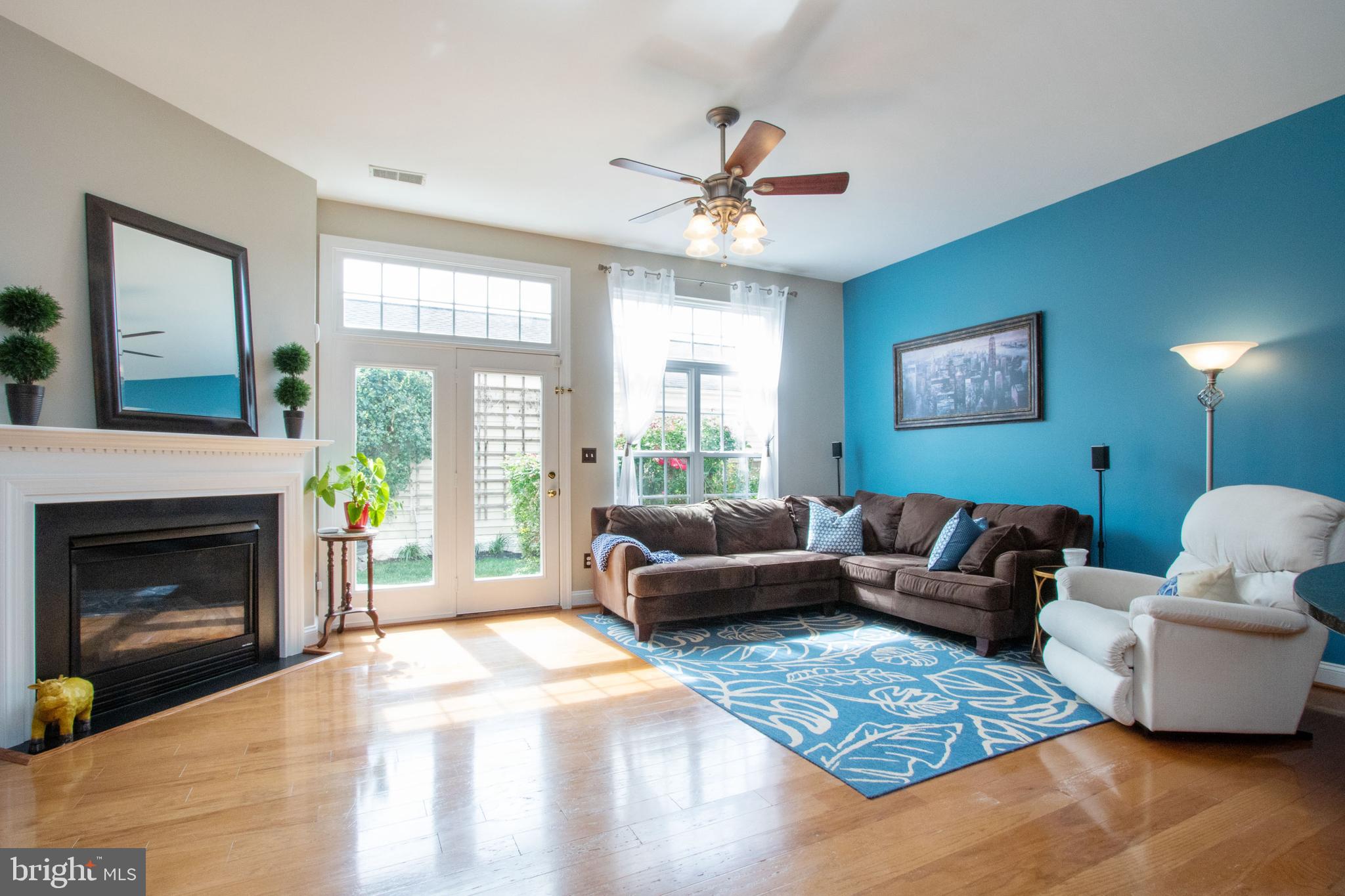 9036 Ribbon Falls Loop Bristow, VA 20136 - Photo 16 of 43 Sunlit Family Room with Cozy Gas Fireplace
