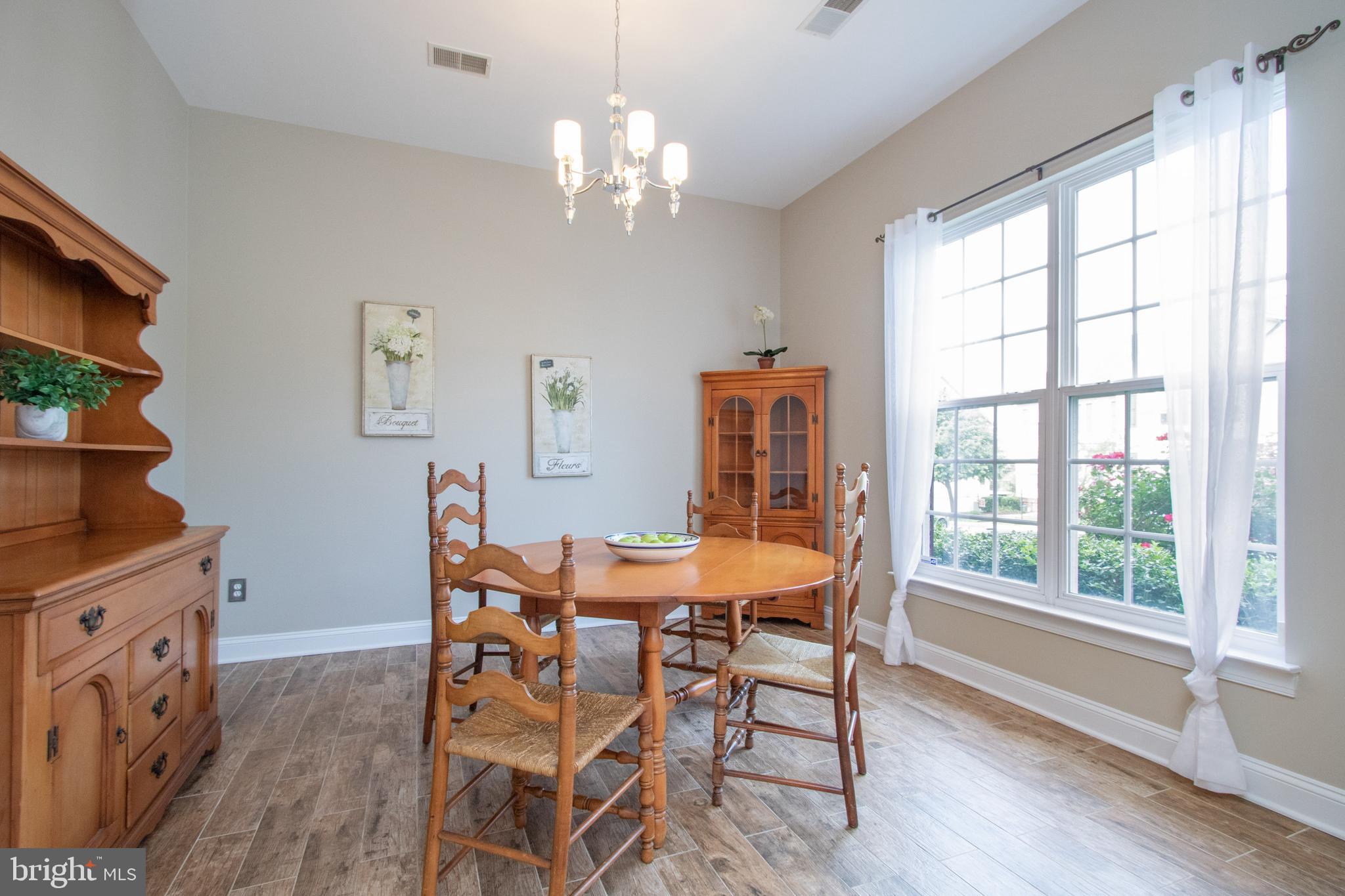 9036 Ribbon Falls Loop Bristow, VA 20136 - Photo 6 of 43 Sunlit Dining Room with Upgraded HDWD-Style Tile