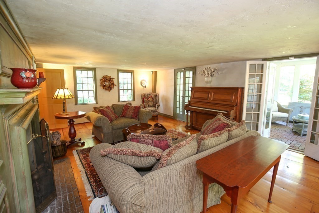 21 Rolfe's Lane Newbury, MA 01951 - Photo 11 of 42 a living room with furniture a flat screen tv and a fireplace