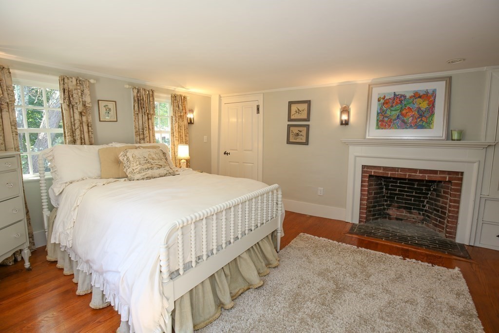 21 Rolfe's Lane Newbury, MA 01951 - Photo 21 of 42 a bedroom with a bed and a fireplace