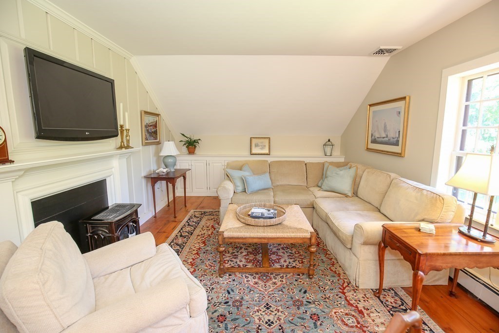 21 Rolfe's Lane Newbury, MA 01951 - Photo 25 of 42 a living room with furniture a flat screen tv and a fireplace