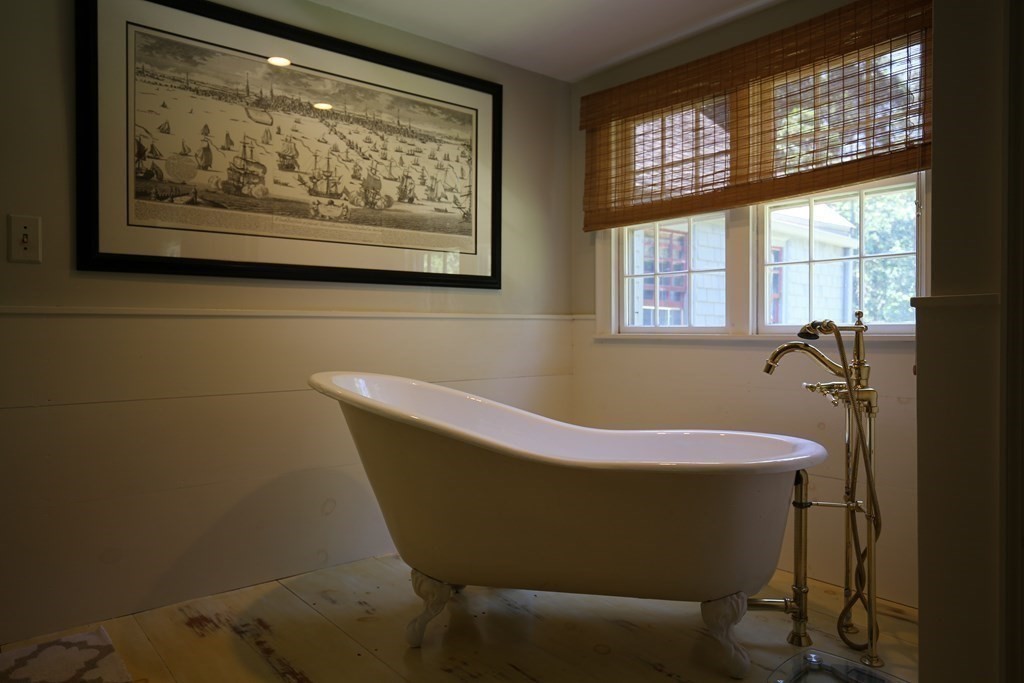 21 Rolfe's Lane Newbury, MA 01951 - Photo 27 of 42 a bath tub sitting in a bathroom next to a window