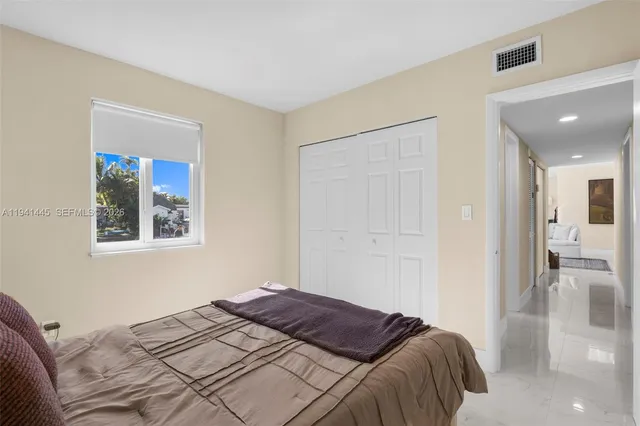 a bedroom with a bed and a painting on the wall