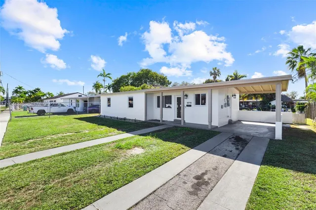 a view of a house with yard and a garden