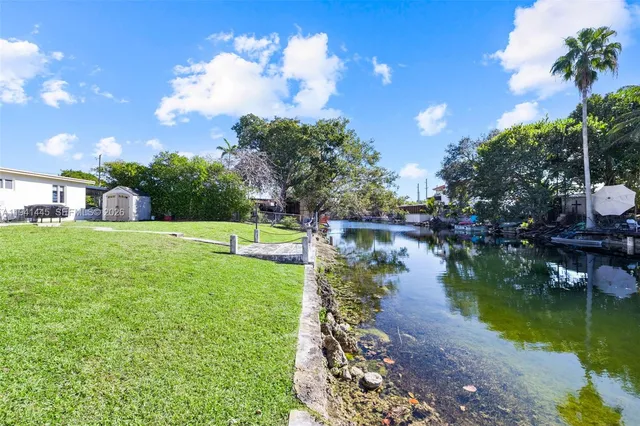 a view of a lake with a house in the background