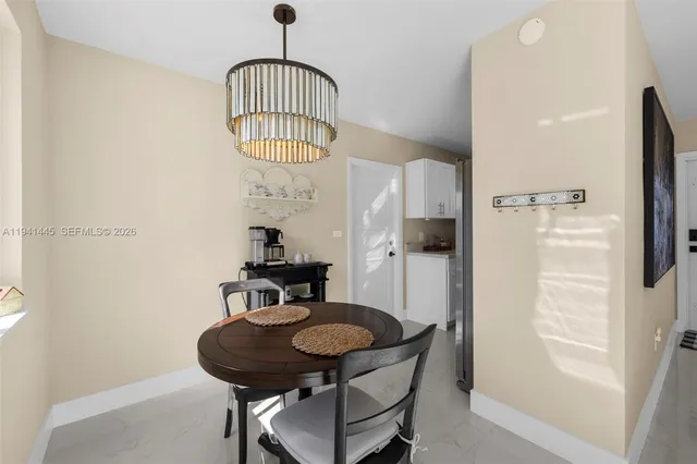 a view of a livingroom with furniture and a window