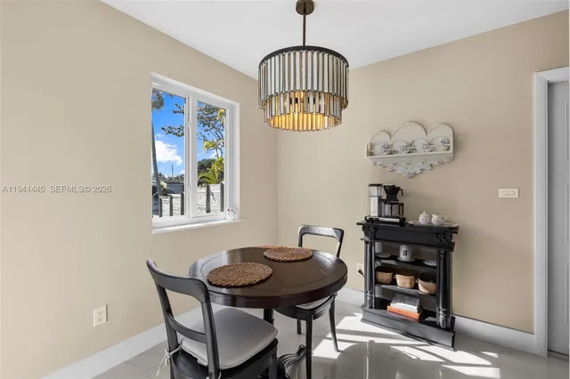 a view of a dining room with furniture and chandelier