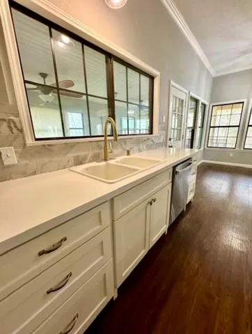 a view of a kitchen with a sink and large window