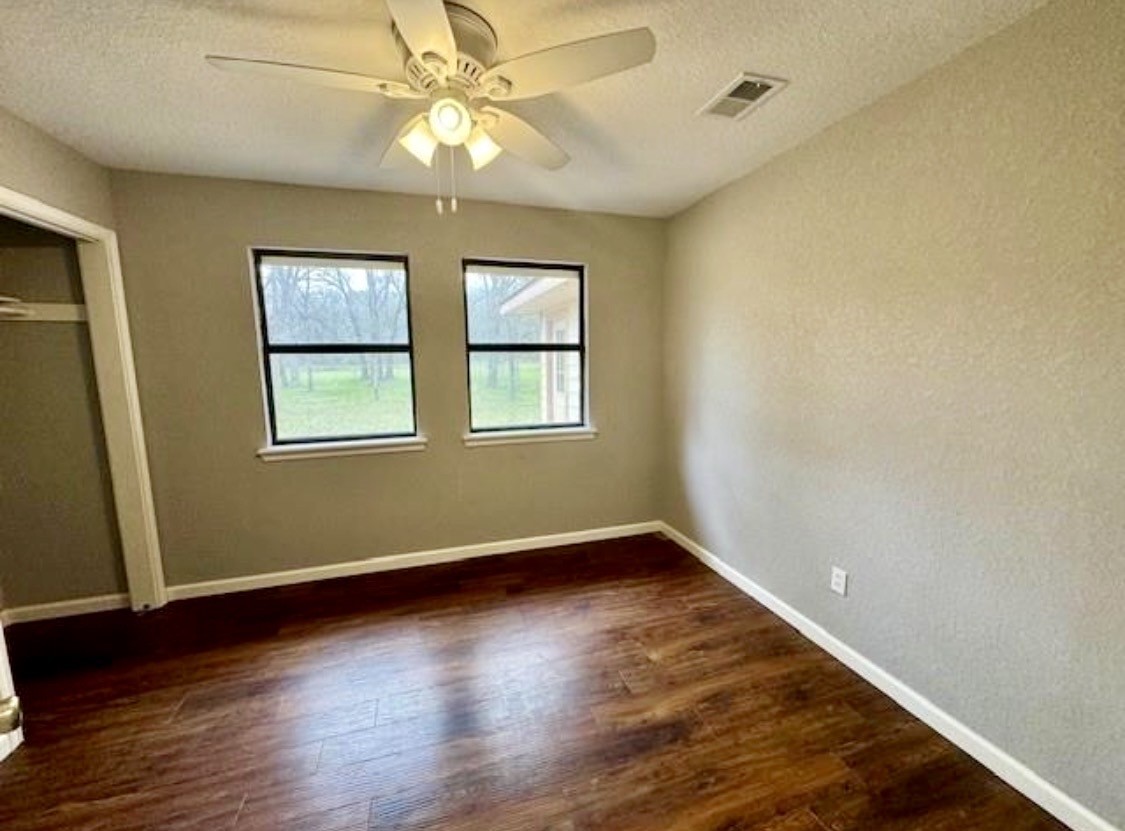 327 County Road 735 Angleton, TX 77515 - Photo 15 of 39 a view of an empty room with wooden floor and a window