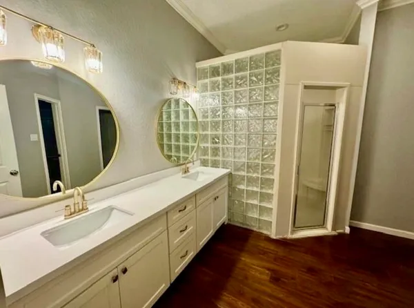 a bathroom with a double vanity sink and a mirror