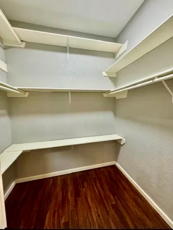 a view of storage and utility room with wooden floor