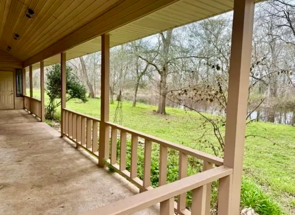 a view of balcony with yard