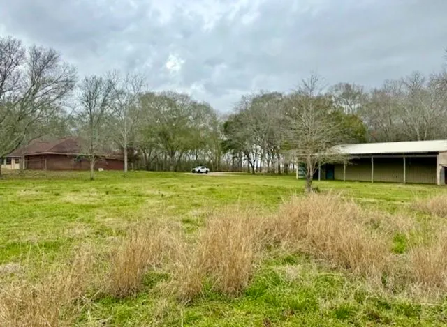 a view of backyard with swimming pool and patio