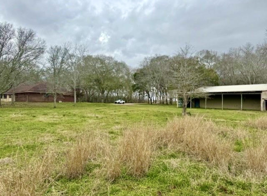327 County Road 735 Angleton, TX 77515 - Photo 26 of 39 a view of a house with a big yard and a large tree
