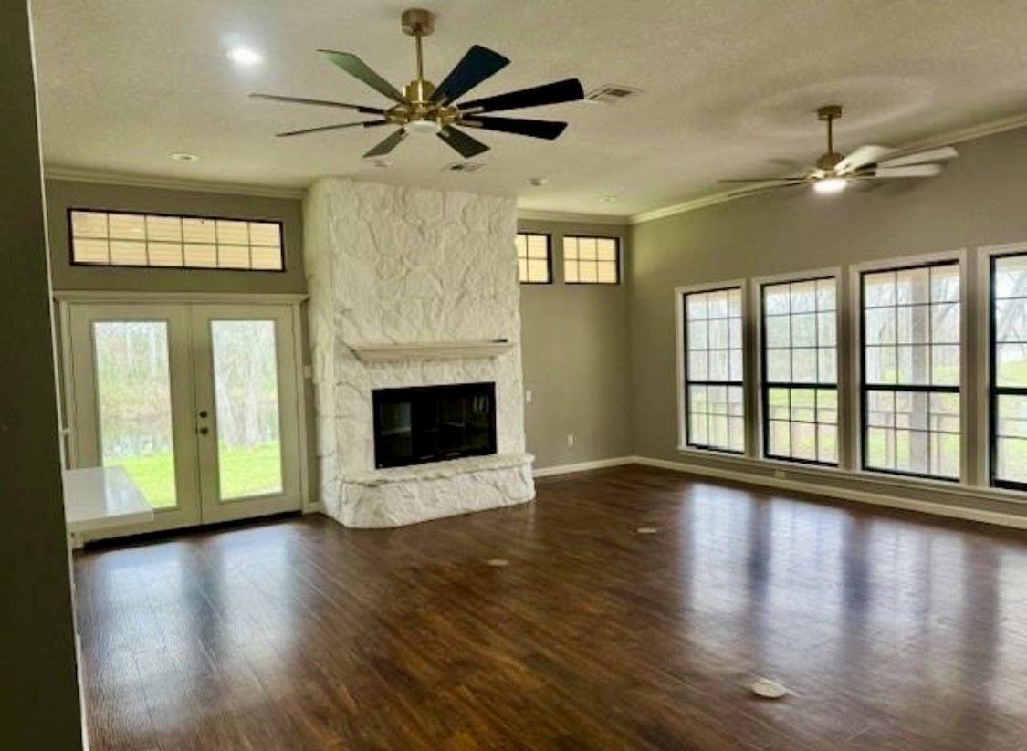 327 County Road 735 Angleton, TX 77515 - Photo 3 of 39 a view of an empty room with wooden floor fireplace and a window