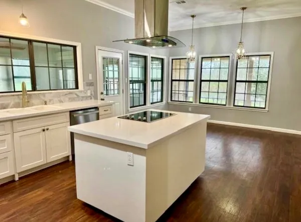a kitchen that has a sink and a stove in it