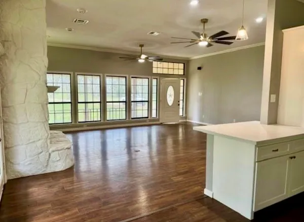 a view of a livingroom with furniture wooden floor and a window