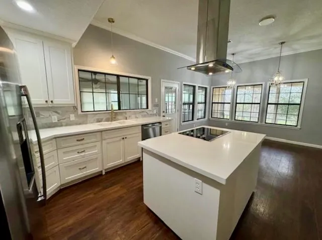 a kitchen that has a sink a stove and a table in it