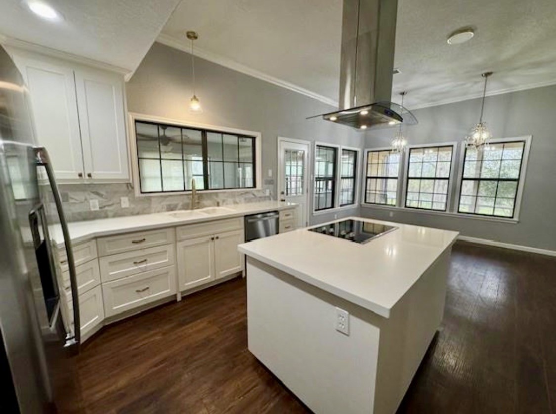 327 County Road 735 Angleton, TX 77515 - Photo 7 of 39 a kitchen that has a sink a stove and a table in it