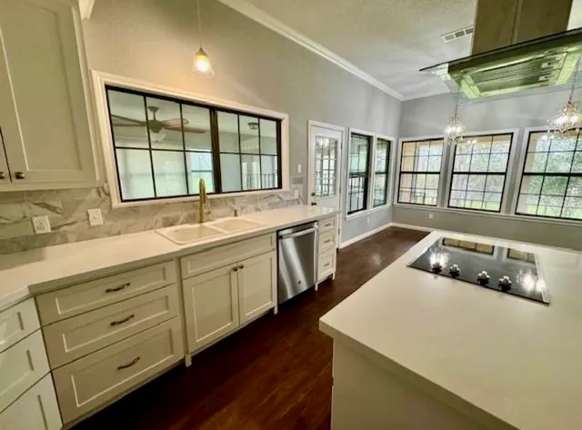 a kitchen with a large window appliances and cabinets