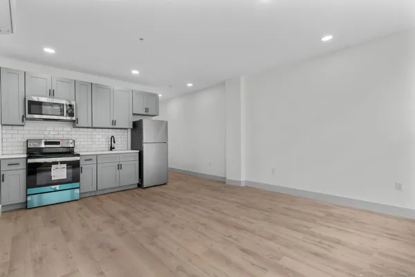 a kitchen with stainless steel appliances a refrigerator and a stove top oven