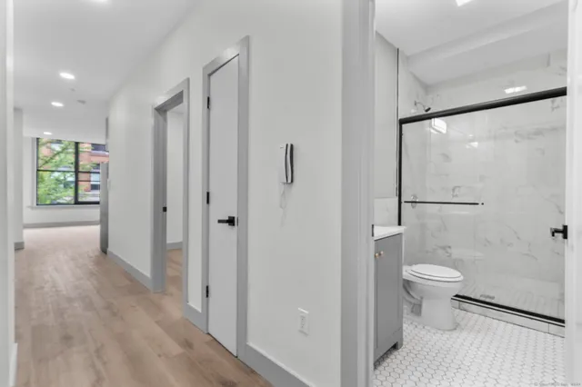 a bathroom with a toilet sink and shower