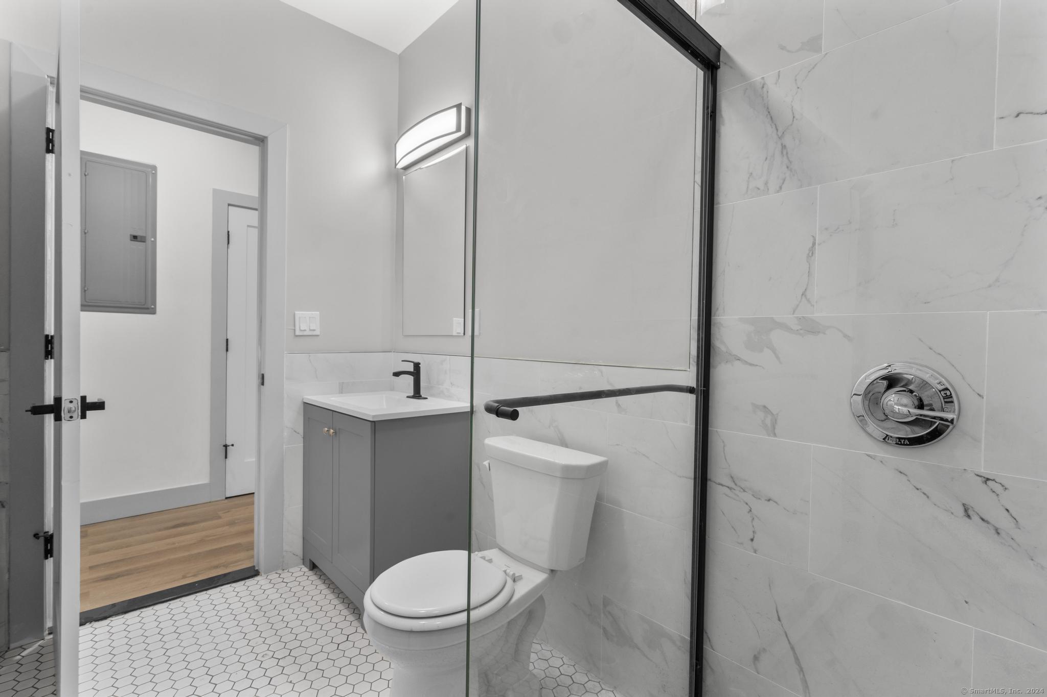 111 Bank Street, Unit 2B Waterbury, CT 06702 - Photo 9 of 15 a bathroom with a sink a toilet and shower