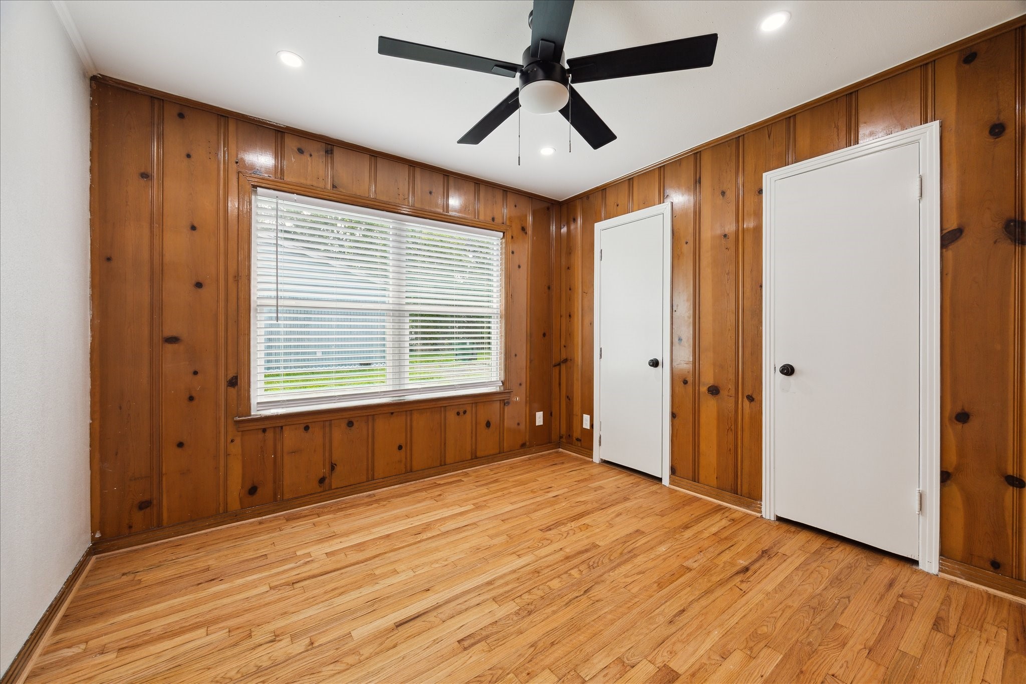522 Barkley Street Houston, TX 77022 - Photo 12 of 18 This beautifully paneled bedroom adds character to the home while enjoying the great amenities of two closets, ceiling fan, recessed lighting, and an oversized window.