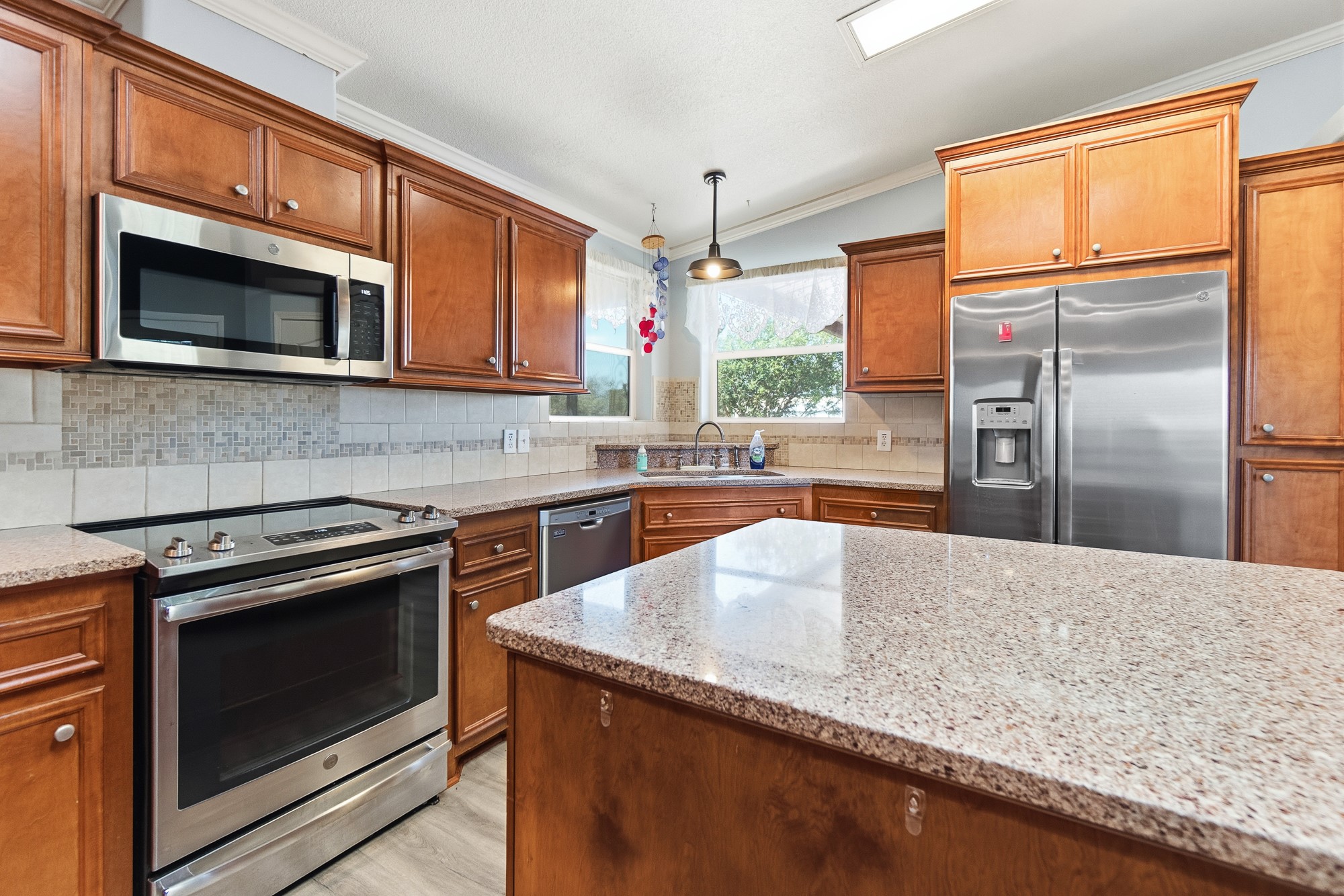 1951 Dowdy Road Seguin, TX 78155 - Photo 5 of 40 Gleaming stone countertops and warm wood cabinetry define this inviting kitchen layout.