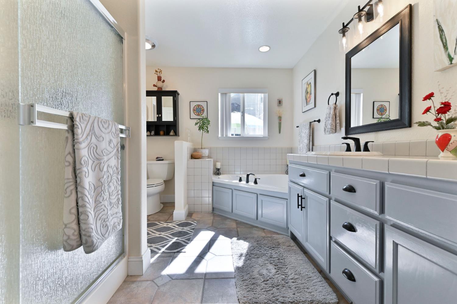 234 Mistletoe Court Angels Camp, CA 95222 - Photo 51 of 80 a bathroom with a double vanity sink mirror and shower