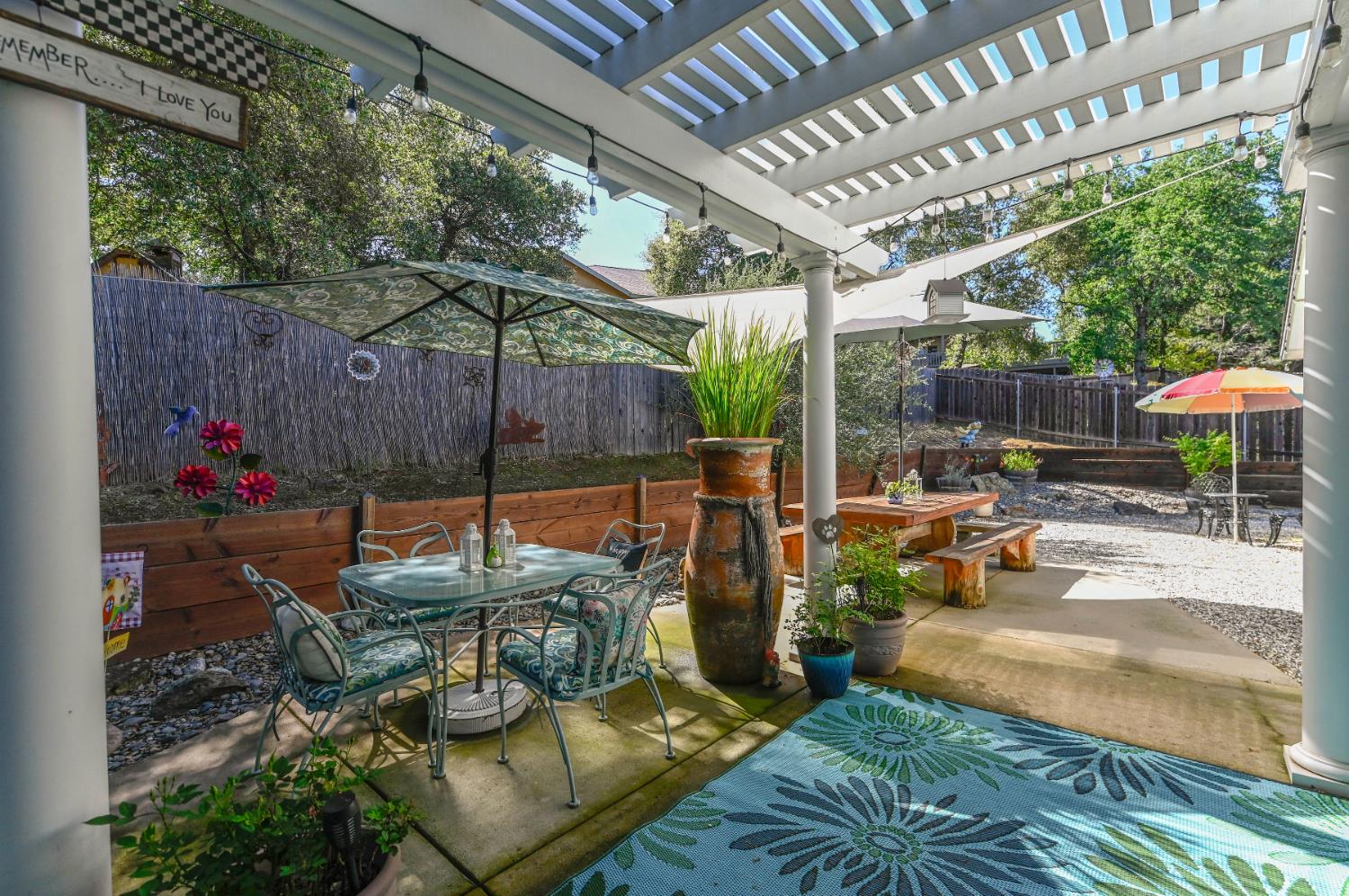 234 Mistletoe Court Angels Camp, CA 95222 - Photo 59 of 80 a view of patio with table and chairs potted plants and floor to ceiling window