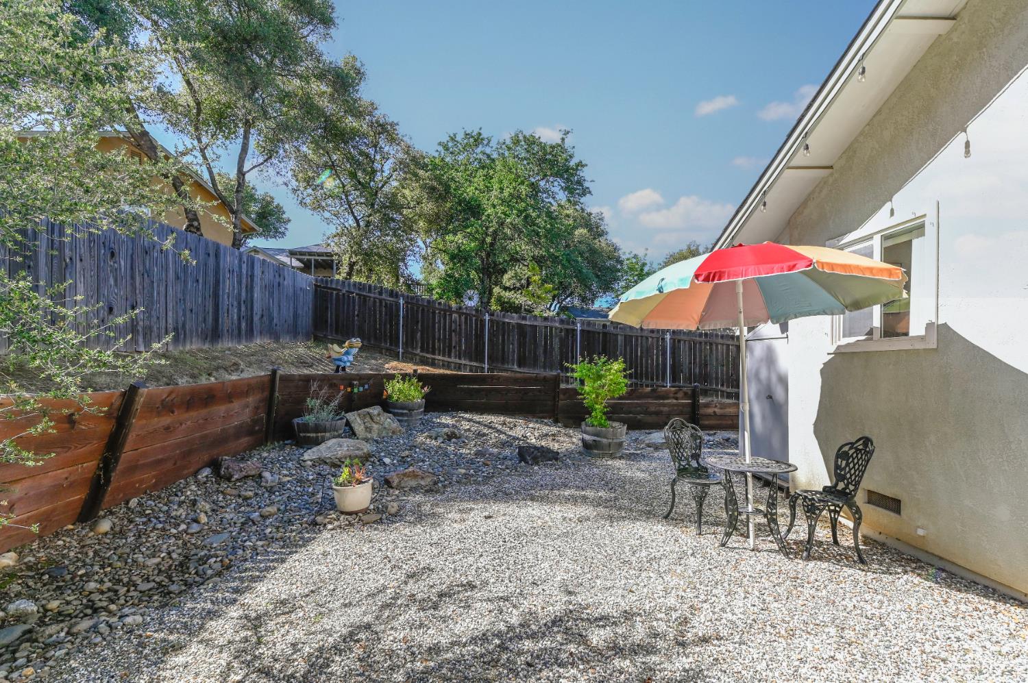 234 Mistletoe Court Angels Camp, CA 95222 - Photo 66 of 80 a backyard of a house with barbeque oven table and chairs
