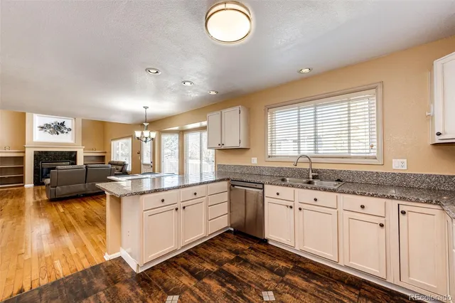 a kitchen with granite countertop a sink cabinets and window