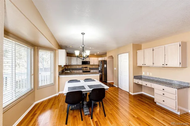 a view of a kitchen with kitchen island and stainless steel appliances