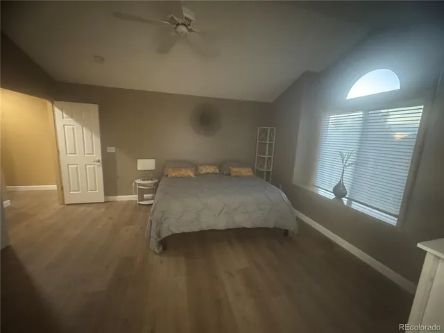 a spacious bedroom with a bed and a window