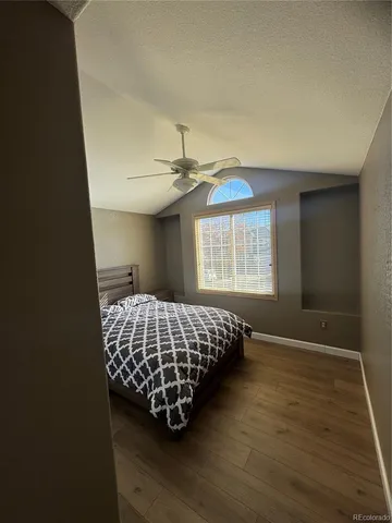 a spacious bedroom with a bed and a window