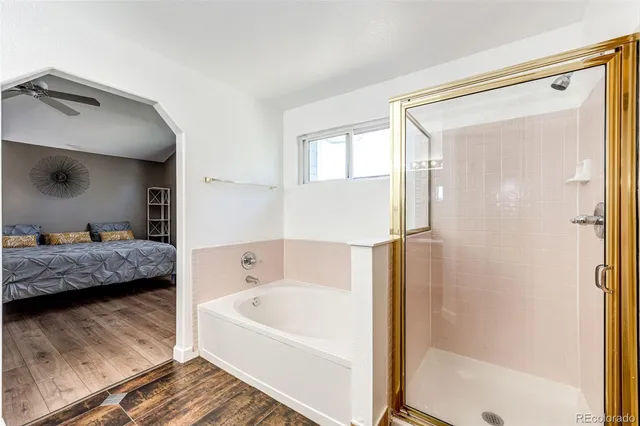 a bathroom with a tub shower and a sink