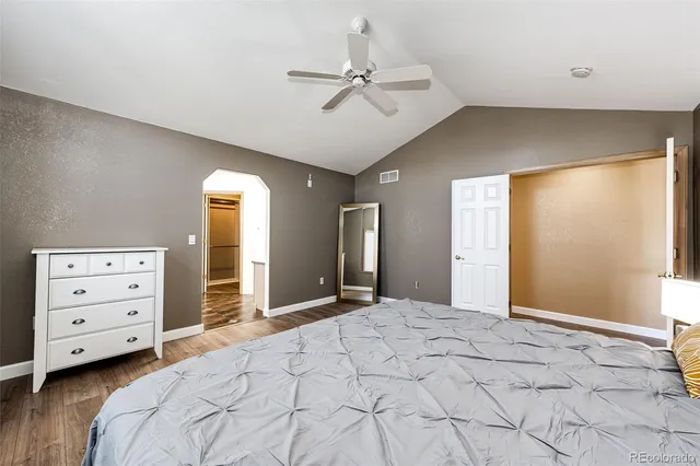 a bedroom with a bed and a ceiling fan