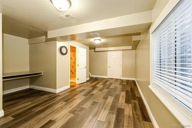 a view of a room with wooden floor and staircase