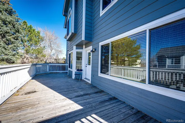 a view of outdoor space with wooden deck and furniture