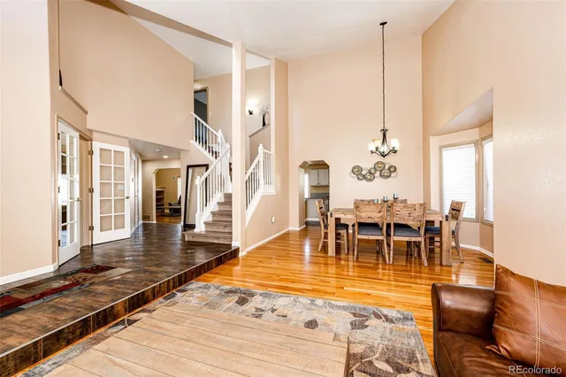a view of a living room and dining room with wooden floor