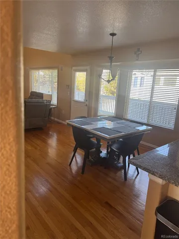 a dining room with furniture and wooden floor