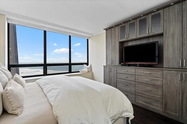 a bedroom with a bed and a flat screen tv