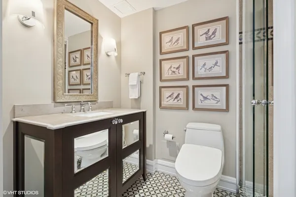 a bathroom with a toilet a sink and mirror