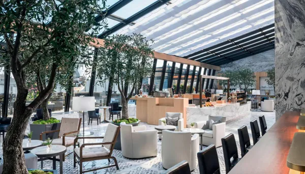 a outdoor space with lots of tables a chairs and a barbeque